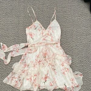 White dress with pink flower accents ruffles